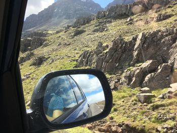 Reflection of car on side-view mirror