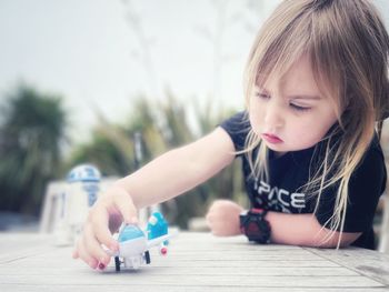 Close-up of girl drawing on table