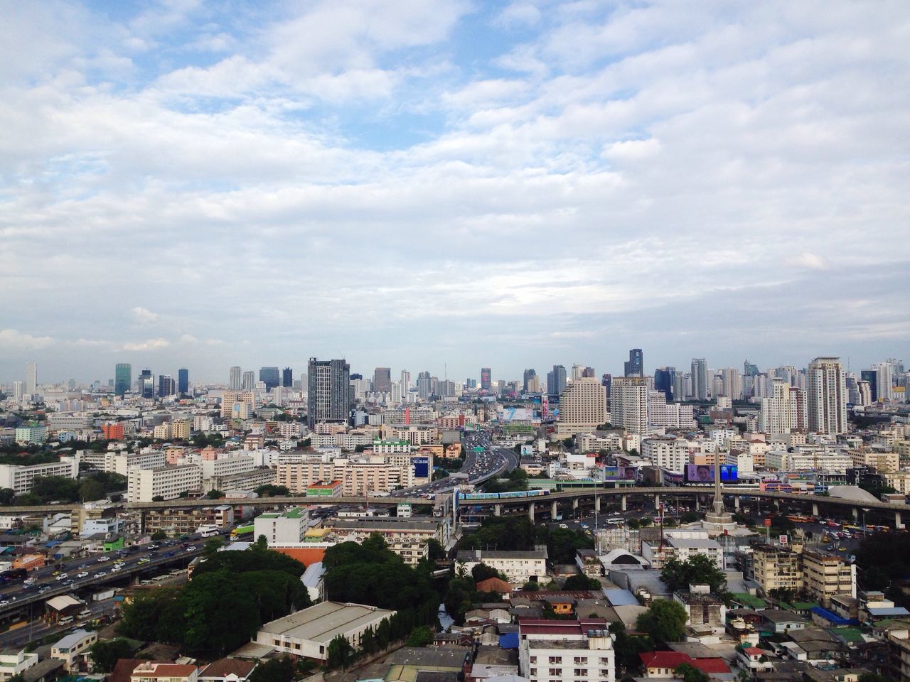 cityscape, city, building exterior, architecture, built structure, sky, cloud - sky, residential district, skyscraper, cloudy, residential building, cloud, city life, tall - high, day, office building, outdoors, no people, modern, urban skyline, overcast, development, tall, elevated view, weather, nature