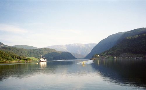 Scenic view of lake and mountains against clear sky