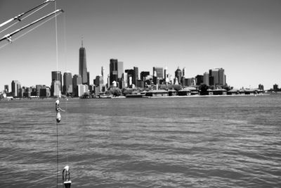Sea and buildings against clear sky