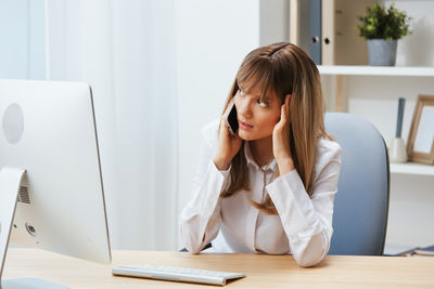 Young woman using laptop at home