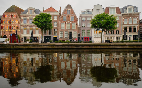 Haarlem, netherlands. panoramic view of traditional dutch houses in a row lining the river sparne.