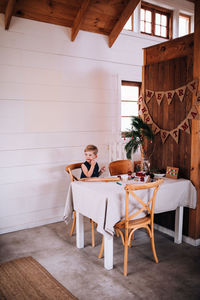 Woman sitting on chair at table