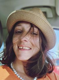 Close-up of young woman wearing hat