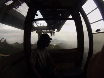 Man looking through window