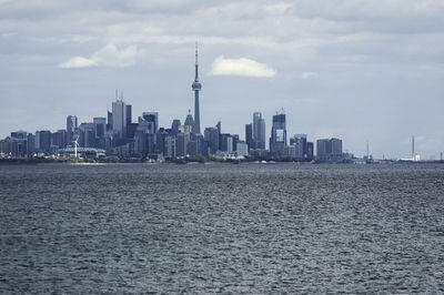 View of cityscape against cloudy sky