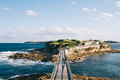 High angle view of footbridge over sea against sky