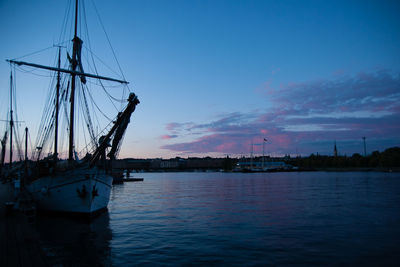 Sailboats in sea against sky during sunset