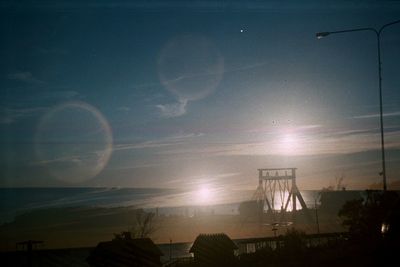 Silhouette built structure against sky during sunset
