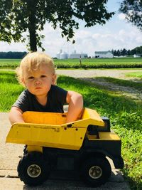 Portrait of baby boy playing with toy at park