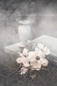 All saints day - artificial flowers on an old grave