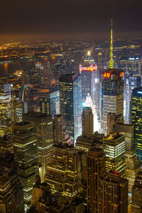 Aerial view of illuminated buildings in city at night