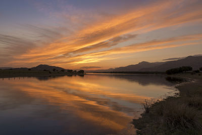 Scenic view of lake against orange sky