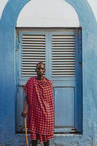 Masai men standing in front of a traditional door in old town