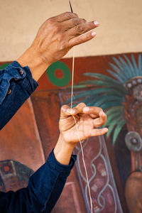 Sharp spine of agave leaves used as sewing needles. tourist guide showing the importance of agave