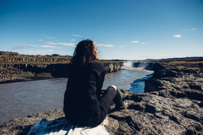 Rear view of man overlooking river