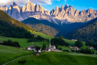 Scenic view of field and mountains against sky