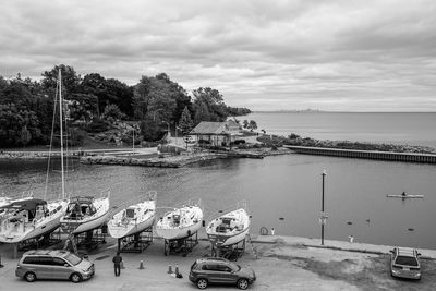 Boats moored in lake against sky