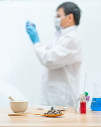 Midsection of man holding ice cream in bowl