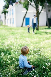 Rear view of boy on field