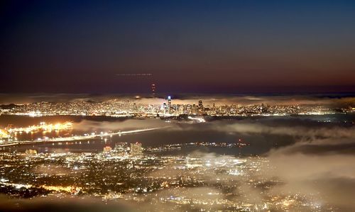 High angle view of illuminated buildings in city at night