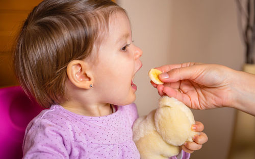 Close-up of cute girl eating food