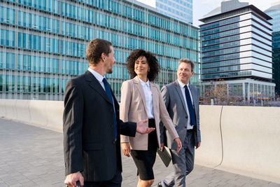 Portrait of business people walking on street