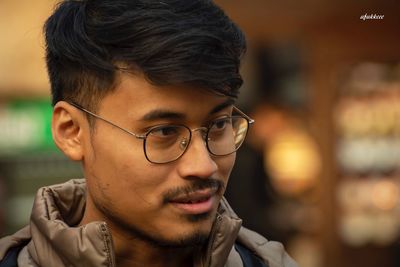 Close-up portrait of young man looking away