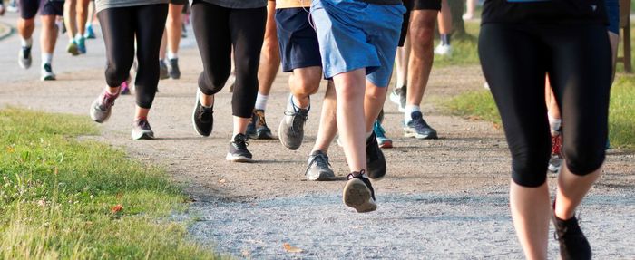 Low section of people running on road