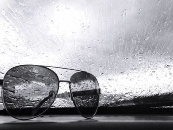 Close-up of wet sunglasses on table