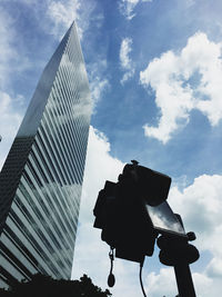 Low angle view of modern building against cloudy sky