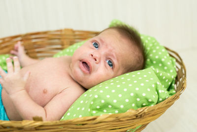 Portrait of cute baby in basket