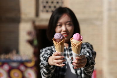 Portrait of woman holding ice cream