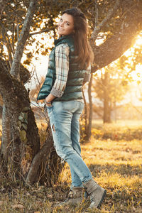 Portrait of young woman standing in forest