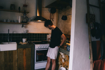 Side view of woman standing in restaurant