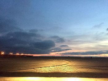 Scenic view of beach against sky during sunset