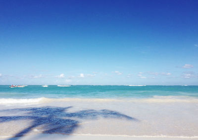 Scenic view of sea against blue sky