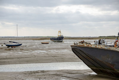 Fisherman boats stuck on the beach in low tide period in leigh-on-sea, uk.