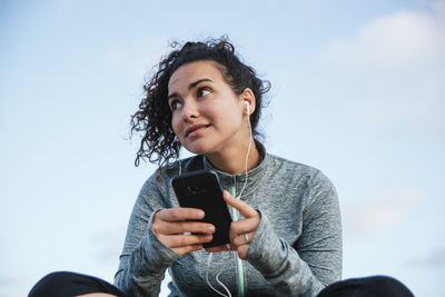 Girl with cellphone and headphones