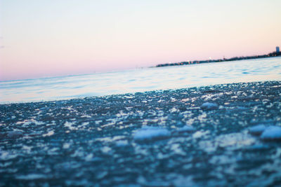 Scenic view of sea against clear sky during sunset