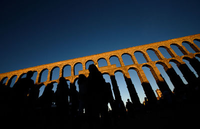 Low angle view of silhouette people against clear sky at night