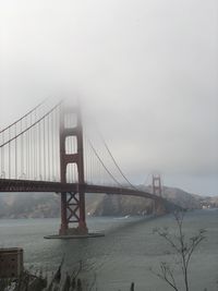 View of suspension bridge in foggy weather