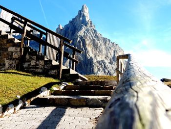 Steps leading towards mountain against sky