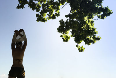 Low angle view of woman undressing