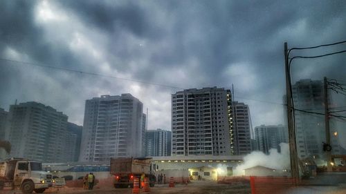 Buildings against cloudy sky