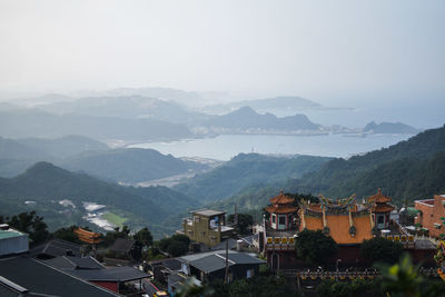 High angle view of townscape and mountains against sky