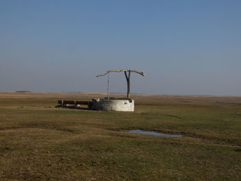 Built structure on field against clear sky