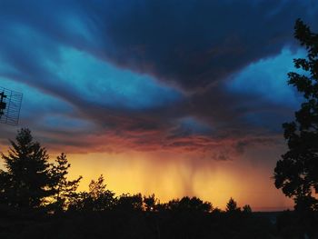 Silhouette trees against sky during sunset