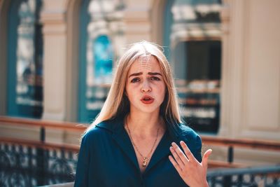 Portrait of beautiful young woman standing outdoors